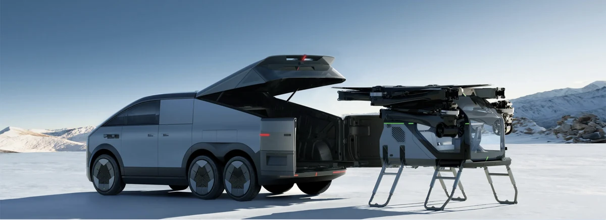 The Land Aircraft Carrier with its rear compartment open and the detached two-seat aircraft beside it, with its rotor arms folded